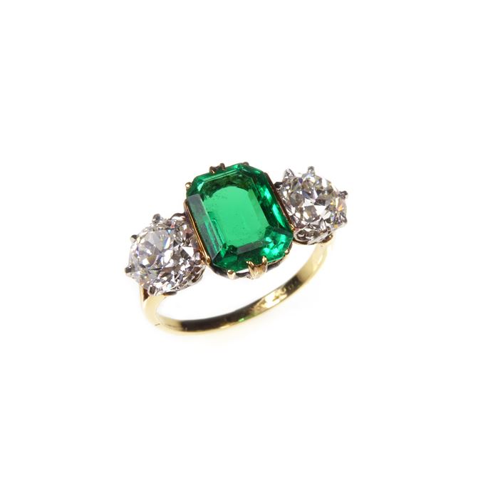Three stone emerald and diamond ring,  the central emerald-cut Colombian emerald claw set | MasterArt